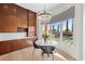 Bright breakfast nook featuring a modern chandelier, white marble table and backyard views at 10923 Willow Heights Dr, Las Vegas, NV 89135