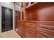 Custom walk-in closet with wood drawers, cabinets, and glass shelving for storage at 10923 Willow Heights Dr, Las Vegas, NV 89135