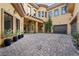 Spacious courtyard with paver stones, ample parking, and elegant architectural details at 10923 Willow Heights Dr, Las Vegas, NV 89135
