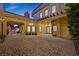 Large, paved courtyard featuring an arched entryway and access to the garage and various points in the home at 10923 Willow Heights Dr, Las Vegas, NV 89135