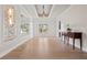 Elegant dining room with tray ceiling, chandelier, decorative wall panels, and natural light at 10923 Willow Heights Dr, Las Vegas, NV 89135