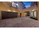 Long, paved driveway leading to a spacious three-car garage and porte-cochere at 10923 Willow Heights Dr, Las Vegas, NV 89135