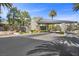 View of the community entrance gate featuring stone architecture and lush landscaping at 10923 Willow Heights Dr, Las Vegas, NV 89135