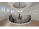 Elegant foyer with chandelier, wrought iron banister, and natural light from multiple windows at 10923 Willow Heights Dr, Las Vegas, NV 89135