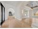 Elegant foyer with high ceilings, arched doorways, hardwood floors, designer lighting, and a grand staircase at 10923 Willow Heights Dr, Las Vegas, NV 89135
