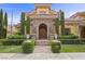 Elegant home featuring a stone archway entrance, manicured landscaping, and a paver walkway at 10923 Willow Heights Dr, Las Vegas, NV 89135