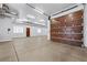 Spacious garage with a dark wood door and ample lighting at 10923 Willow Heights Dr, Las Vegas, NV 89135