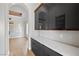Bright, modern hallway with glossy black cabinets and white countertops at 10923 Willow Heights Dr, Las Vegas, NV 89135