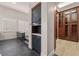 Stylish hallway with sleek cabinets and access to a custom closet with wooden drawers and shelves at 10923 Willow Heights Dr, Las Vegas, NV 89135