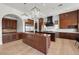 Spacious kitchen boasts dark wood cabinetry, stainless steel appliances, and pendant lighting fixtures at 10923 Willow Heights Dr, Las Vegas, NV 89135