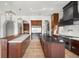 A stylish kitchen features wood floors, stainless steel appliances, and dark countertops at 10923 Willow Heights Dr, Las Vegas, NV 89135