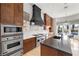 Modern kitchen with stainless steel appliances, a black range hood and white countertops with island seating at 10923 Willow Heights Dr, Las Vegas, NV 89135