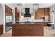 This gorgeous kitchen features wooden cabinets, an island, and stainless steel appliances at 10923 Willow Heights Dr, Las Vegas, NV 89135