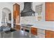 Kitchen with stainless steel appliances, a black range hood, a gray island and plenty of counter space at 10923 Willow Heights Dr, Las Vegas, NV 89135