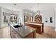 Open concept kitchen with modern lighting, an island with seating and access to the backyard at 10923 Willow Heights Dr, Las Vegas, NV 89135