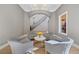 Inviting living room featuring a seating area, neutral colors, and views of the entryway and staircase at 10923 Willow Heights Dr, Las Vegas, NV 89135