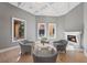 Cozy living room with a coffered ceiling, fireplace, and seating arrangement overlooking the courtyard at 10923 Willow Heights Dr, Las Vegas, NV 89135
