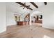 Open-concept living room with hardwood floors, a stone fireplace, a stylish bar, and ample space for entertaining at 10923 Willow Heights Dr, Las Vegas, NV 89135