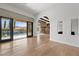 Bright living room with hardwood floors, stone fireplace, and sliding doors to the pool at 10923 Willow Heights Dr, Las Vegas, NV 89135