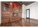 Living room showcasing a custom built-in unit with a fireplace and display shelves on hardwood floors at 10923 Willow Heights Dr, Las Vegas, NV 89135