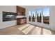 Spacious living room featuring a fireplace, built-in bar, and sliding glass doors to the outside at 10923 Willow Heights Dr, Las Vegas, NV 89135