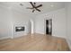 Bright living room featuring a fireplace, ceiling fan, and an archway leading to another room at 10923 Willow Heights Dr, Las Vegas, NV 89135