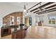 Spacious living room with beams, stone arch, bar, and large windows offering natural light at 10923 Willow Heights Dr, Las Vegas, NV 89135
