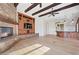 Bright living room boasts a stone fireplace, wood beams, built-in cabinets, and a spacious open layout at 10923 Willow Heights Dr, Las Vegas, NV 89135