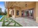 Beautiful outdoor patio featuring decorative turf and access to the pool and backyard at 10923 Willow Heights Dr, Las Vegas, NV 89135