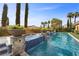 Luxury pool featuring a waterfall feature and mature landscaping, ideal for entertaining and relaxation at 10923 Willow Heights Dr, Las Vegas, NV 89135