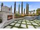 Outdoor fireplace next to the pool at 10923 Willow Heights Dr, Las Vegas, NV 89135