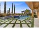Beautiful pool with water features and decorative turf at 10923 Willow Heights Dr, Las Vegas, NV 89135