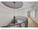 Elegant staircase with custom iron railing, large chandelier, and neutral walls at 10923 Willow Heights Dr, Las Vegas, NV 89135