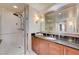 This bathroom has a glass shower and a granite counter at 135 E Harmon Ave # 2721, Las Vegas, NV 89109