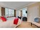 This bedroom boasts city views from large windows and comfortable seating area at 135 E Harmon Ave # 2721, Las Vegas, NV 89109