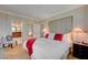 This bedroom features a tufted headboard, red throw blanket, and cozy lighting at 135 E Harmon Ave # 2721, Las Vegas, NV 89109