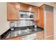 Well-equipped kitchenette with modern stainless steel appliances, sleek countertops, and ample storage at 135 E Harmon Ave # 2721, Las Vegas, NV 89109