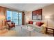 Bright living room with comfortable seating, decorative pillows, and views from a private balcony at 135 E Harmon Ave # 2721, Las Vegas, NV 89109