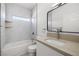 Clean bathroom with single vanity, bathtub, and window at 251 Glenoaks St, Pahrump, NV 89048