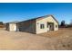 Single-story home with stucco exterior, covered patio, and spacious backyard at 251 Glenoaks St, Pahrump, NV 89048