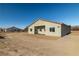 Single-story home with stucco exterior, covered patio, and desert landscaping at 251 Glenoaks St, Pahrump, NV 89048