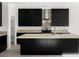 Modern kitchen with dark cabinetry, an island, and stone backsplash at 251 Glenoaks St, Pahrump, NV 89048
