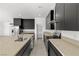 Kitchen with dark cabinetry, quartz countertops, and stainless steel appliances at 251 Glenoaks St, Pahrump, NV 89048
