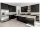 Island kitchen with quartz countertops, stainless steel appliances, and dark cabinetry at 251 Glenoaks St, Pahrump, NV 89048
