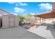 Private backyard featuring a covered patio, storage shed, brick pavers, and mature landscaping at 2829 Forrest Duke Ct, Las Vegas, NV 89108