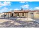 Backyard featuring a covered patio, brick pavers, mature landscaping, and block fencing at 2829 Forrest Duke Ct, Las Vegas, NV 89108