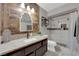 Stylish bathroom with wood accent wall, granite counters, and tiled shower with glass door at 2829 Forrest Duke Ct, Las Vegas, NV 89108