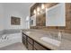 Bathroom boasts & sinks, wood accent wall, and a soaking tub at 2829 Forrest Duke Ct, Las Vegas, NV 89108