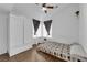 Cozy bedroom with ceiling fan, built-in desk area, and ample natural light at 2829 Forrest Duke Ct, Las Vegas, NV 89108