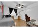 This bedroom has laminated wood floors and a ceiling fan and light fixture at 2829 Forrest Duke Ct, Las Vegas, NV 89108